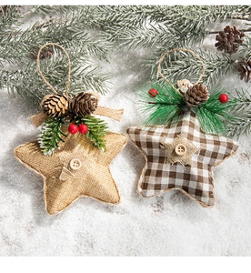 Detail of burlap star ornaments with pine cones and berries on a snowy background