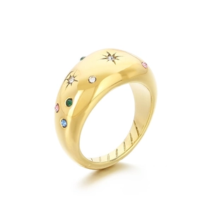 Minimalist gold bombé ring with colorful starburst zircon inlay on a white background