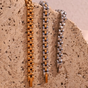 Detailed macro shot of 18K gold-plated stainless steel watch-style link bracelets