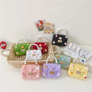 Kids quilted jelly crossbody bag with pearl handle and cartoon charms in multiple colors