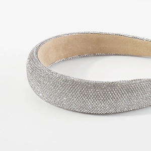 Close-up of thick sponge headband featuring fully encrusted sparkling silver rhinestones