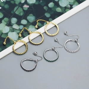 Macro detail of adjustable s925 silver chain rings with sparkling zircon inlay