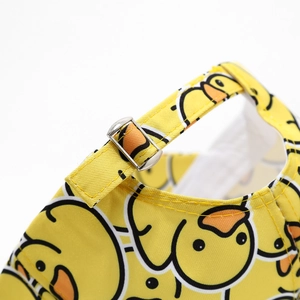 Detail of adjustable metal buckle and cartoon duck print on yellow canvas baseball cap