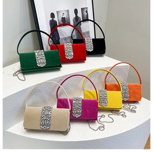 Macro shot of colorful velvet evening bags with sparkling rhinestone buckles and chain straps
