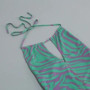 Detail of green and purple zebra print halter dress showing fine woven texture and strap