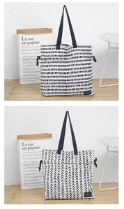 Detail of canvas tote bags featuring horizontal stripes and V-shaped geometric patterns