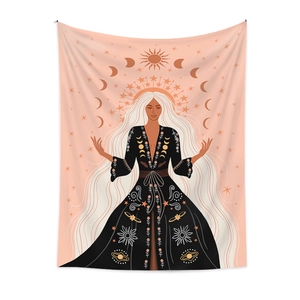 Detail of bohemian tapestry featuring a mystical woman with moon and celestial patterns