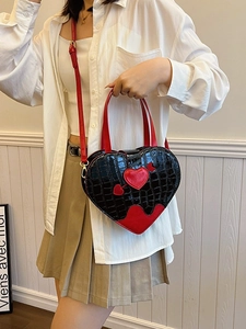 Fashionable heart-shaped crossbody bag with black crocodile texture and red arrow accent