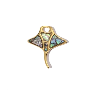 Golden manta ray pendant with colorful abalone shell inlay on white background