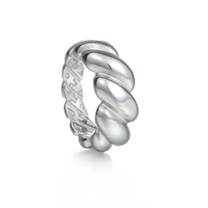 Macro detail of silver croissant ring showing twisted texture and hollow inner structure