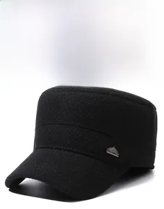 Macro detail of black herringbone winter hat featuring a metallic mountain peak logo