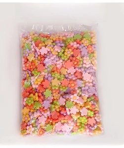 Macro shot of colorful resin flower charms for DIY crafts in macaron pastel tones