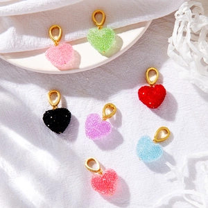 DIY colorful heart pendants with grainy texture and golden clasps for jewelry making