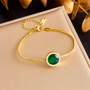 Gold S925 snake chain bracelet featuring a round emerald green gemstone pendant