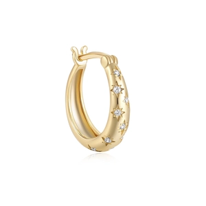 Macro shot of gold hoop earring featuring sparkling star-shaped cubic zirconia stones
