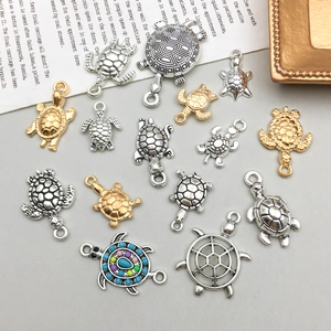 Detailed assortment of antique silver and gold sea turtle pendants for DIY jewelry