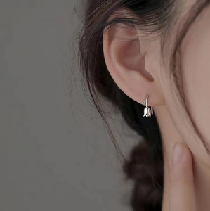 Elegant silver tulip flower stud earrings shown on model for a minimalist style