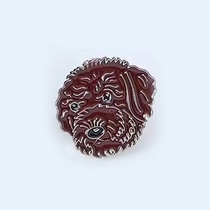Detailed view of dark brown poodle enamel pin with silver metal outlines and curly hair texture