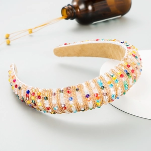 Close-up of Bohemian headband with colorful crystals and woven gold chains detail