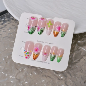 Macro view of 3D pink floral and leopard print press-on nails on a display board
