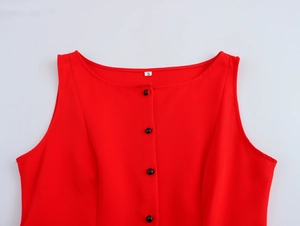 Close-up of red sleeveless top featuring a size S label and row of small black buttons