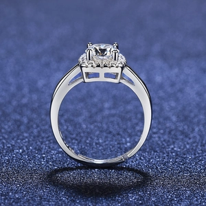 Macro shot of a silver adjustable ring featuring a round zircon and a square halo setting