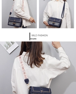 Detail of navy blue leather patchwork tote with ethnic embroidered strap and star lock