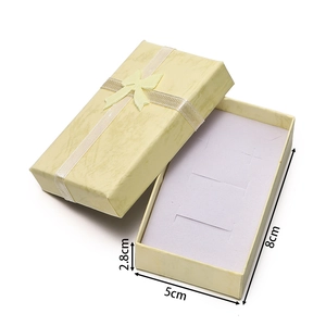 Detail view of a 8x5x2.8cm yellow jewelry gift box with bow and interior foam insert