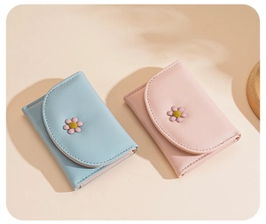Detail showing two sweet PU leather tri-fold wallets with cute daisy floral accents