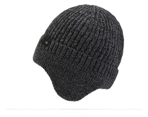 Detailed texture of dark grey knit earflap hat with SPORT label and ribbed pattern