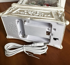Detail view of Christmas music box base with USB port, battery compartment and 3-way switch