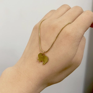 Detailed view of an 18K gold-plated elephant pendant on a sleek snake chain necklace