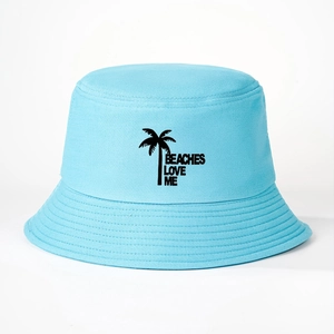 Detail of light blue cotton bucket hat featuring palm tree and Beaches Love Me print