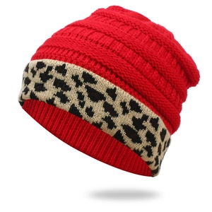 Detailed macro view of the thick red knit texture and leopard print cuff on the winter hat