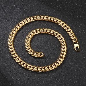 Detailed view of a gold Cuban link chain necklace with lobster clasp on black background