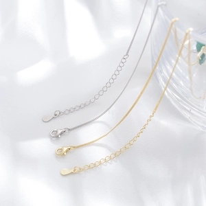 Close-up of S925 sterling silver lobster clasp and extension chain in gold and silver