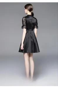Back view of elegant black satin mini dress with lace patchwork and pleated high waist