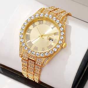 Luxury gold hip-hop watch with iced-out diamonds and roman numerals on white pillow