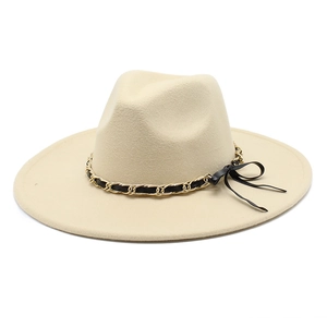 Detail of beige wool fedora featuring a golden metal chain and black ribbon band