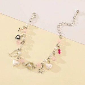 Detail of sweet y2k style charm bracelet with star, heart pendants and colorful beads