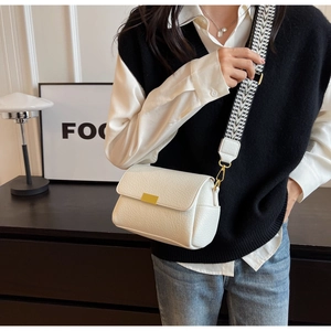 Detail of white lychee texture square bag with geometric wide strap and gold buckle