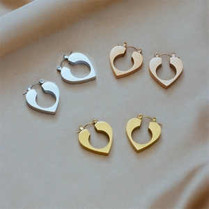 Three pairs of heart-shaped hollow hoop earrings in silver, gold, and rose gold finish