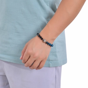 Detail of beaded men's bracelet with black faceted beads and blue tiger eye stone