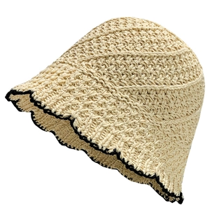 Handwoven beige straw bucket hat with black wavy brim design on a clean white background