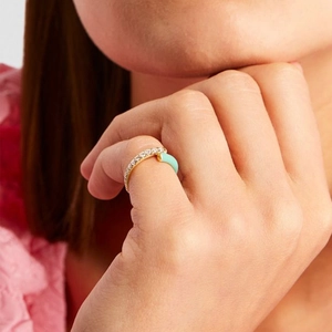 Macro shot of double-layer gold copper ring with turquoise enamel and zircon inlays