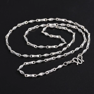 Macro shot of S925 silver heart necklace chain with geometric links and S-hook clasp