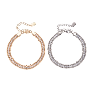 Adjustable double-row rhinestone chain bracelet in gold and silver finish on white background