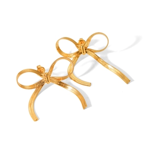 Detail shot of golden 18k bow earrings featuring delicate snake chain weave texture