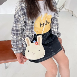 White rabbit crossbody bag for kids with brown ears and red flower detail shown on model