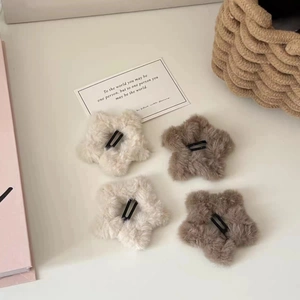 Plush star-shaped hair clips in beige and brown colors with black metal clips